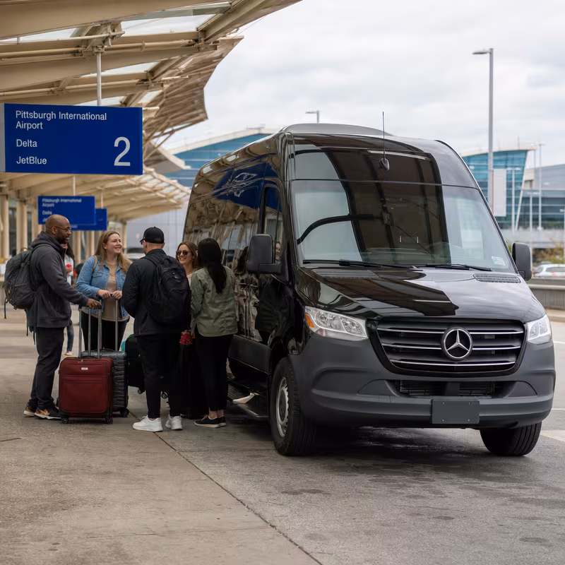 Group boarding a white charter bus for Airport Transportation transportation in Pittsburgh