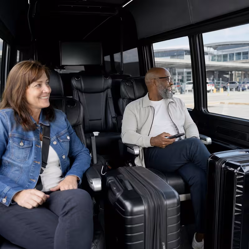 Passengers loading luggage while boarding an Pittsburgh group shuttle
