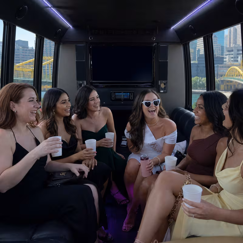 Party bus interior with wraparound leather seating and LED lighting in Pittsburgh
