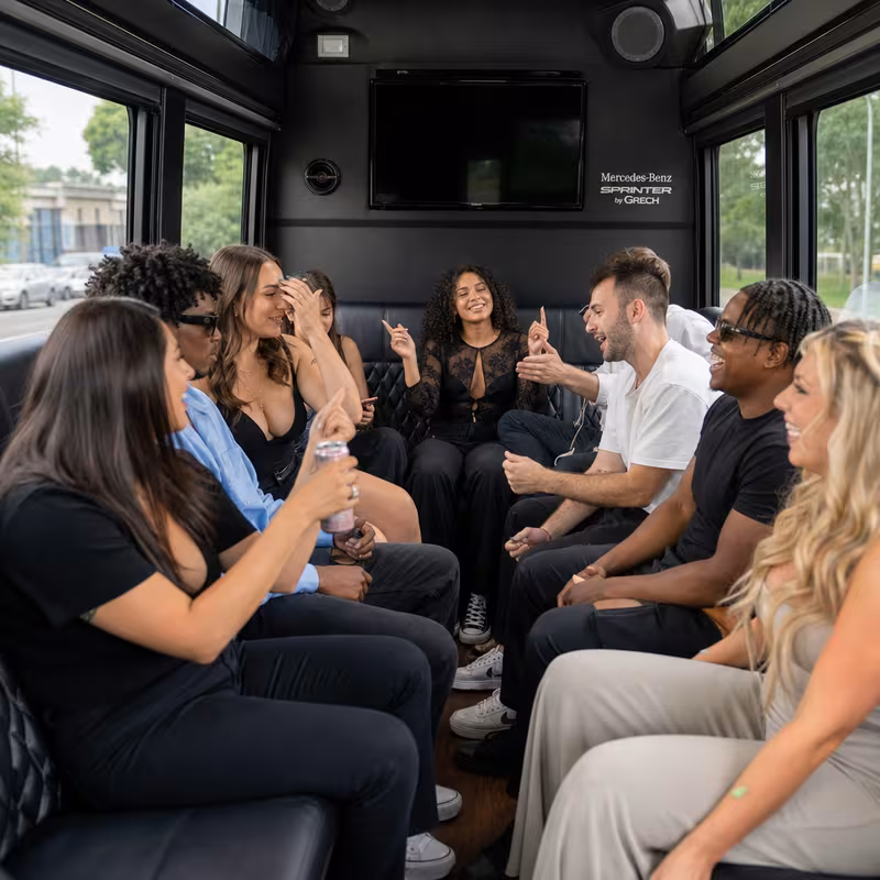 Group boarding a white charter bus for Concert Transportation transportation in Pittsburgh