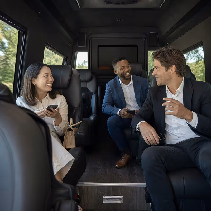 Group boarding a white charter bus for Corporate Transportation transportation in Pittsburgh