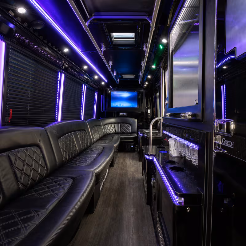Party bus interior with wraparound leather seating and LED lighting in Pittsburgh
