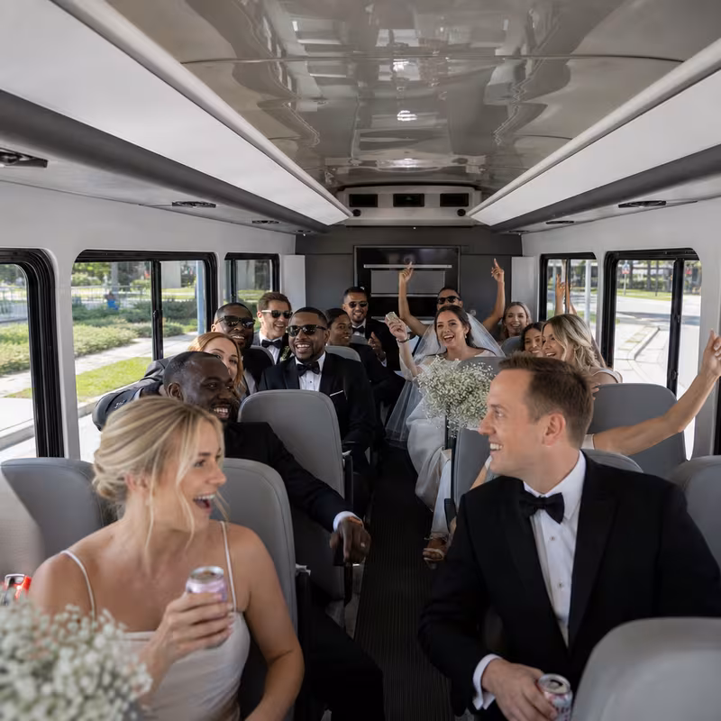 Group boarding a white charter bus for Wedding Transportation transportation in Pittsburgh