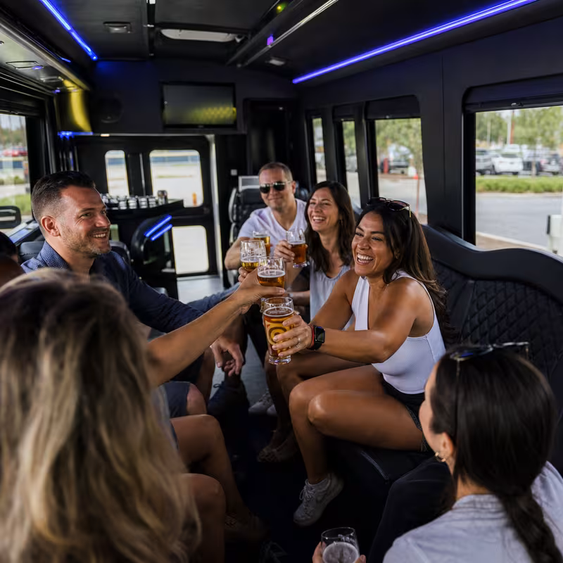 Group boarding a white charter bus for Winery & Brewery Tour Transportation transportation in Pittsburgh
