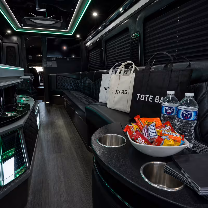 Party bus interior with wraparound leather seating and LED lighting in Pittsburgh